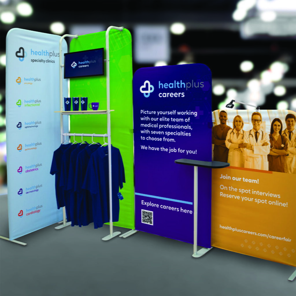 branded tradeshow display, with promotional products, banners, and polos